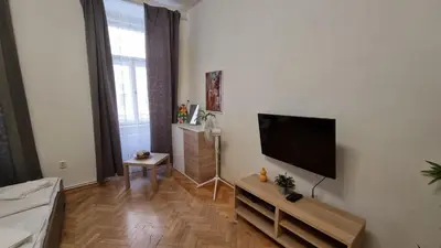 a living room with a flat screen tv on a wall at Apartment Krakovska 20 in Prague