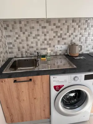 a kitchen with a sink and a washing machine at Arbes 10 - At the yellow Duck in Prague