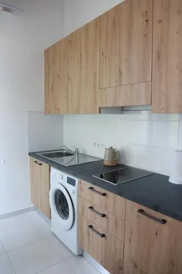 a kitchen with a sink and a washing machine at Arbes 10 - At the yellow Duck in Prague