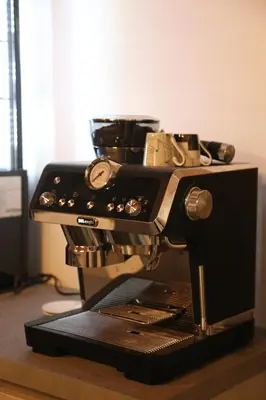 a black sewing machine sitting on top of a table at Arbes 10 - At the yellow Duck in Prague