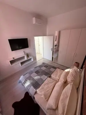 a living room with a couch and a flat screen tv at Arbes 10 - At the yellow Duck in Prague