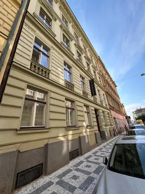 a building on a street with a car parked next to it at Arbes 10 - At the yellow Duck in Prague