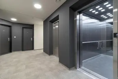 a large empty room with glass doors in a building at Central Tiny Flat, 1GB WiFi, SMART TV, Air Condition in Prague
