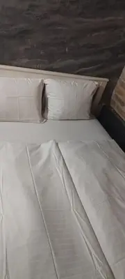 a bed with white sheets and pillows at Alba Hostel in Prague