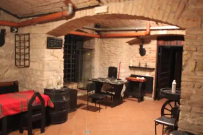 a living room with a table and a piano at Alba Hostel in Prague