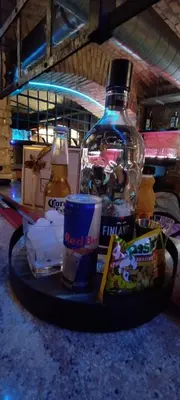 a bottle of alcohol and a drink on a tray at Alba Hostel in Prague