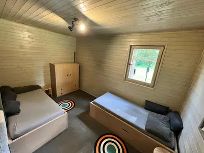a small room with a bed and a window at Biotop Kotlyk in Netvořice