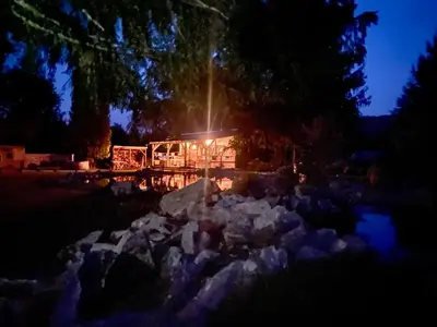 a lit up house at night with a pile of snow at Biotop Kotlyk in Netvořice