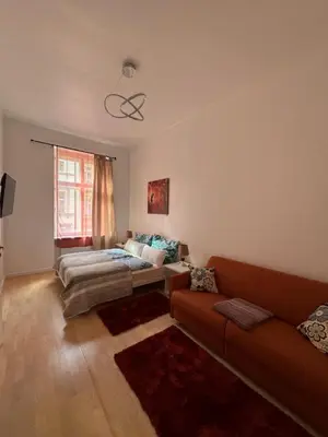 a living room with a couch and a bed at Arbes 13 - Sweet Home in Prague