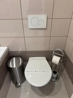 a bathroom with a toilet and a trash can at Arbes 13 - Sweet Home in Prague