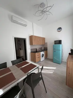 a kitchen with a table and chairs in a room at Arbes 13 - Sweet Home in Prague