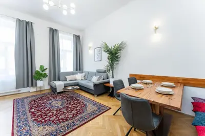 a living room with a table and a couch at Rentero Apartment, 10 minutes Wenceslas Square, Prague in Prague