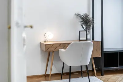a desk with a white chair in a room at Rentero Apartment, 10 minutes Wenceslas Square, Prague in Prague
