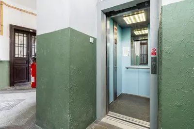 an entrance to a building with a green wall at Rentero Apartment, 10 minutes Wenceslas Square, Prague in Prague