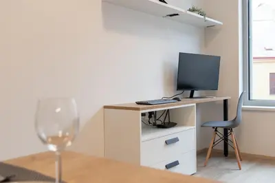 a room with a desk with a computer and a chair at SMART Studio with Ultra Fast 1Gbps WiFi and Air Conditioning in Prague
