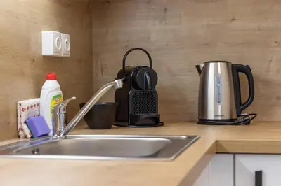 a kitchen counter with a sink and a tea kettle at SMART Studio with Ultra Fast 1Gbps WiFi and Air Conditioning in Prague