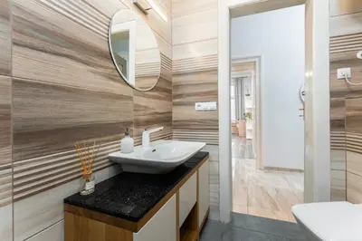 a bathroom with a sink and a mirror at Rentero Friendly Apartment near Wenceslas Square in Prague