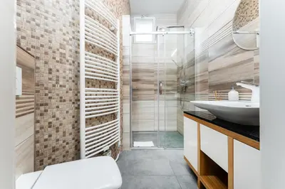 a bathroom with a glass shower and a sink at Rentero Friendly Apartment near Wenceslas Square in Prague