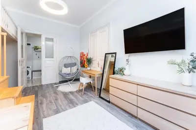 a living room with a flat screen tv on a wall at Rentero Friendly Apartment near Wenceslas Square in Prague