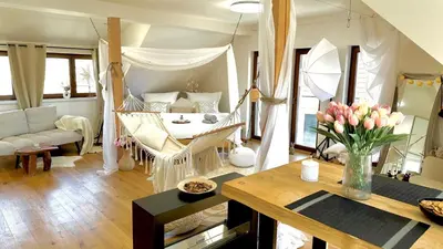 a living room with a hammock in a living room at STUDIO KRÁLOVICE Apartment in Prague