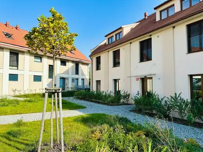 a garden with a tower in front of a building at STUDIO KRÁLOVICE Apartment in Prague