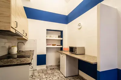 a kitchen with blue and white walls and a counter at Sweet Home by Ruterra in Prague