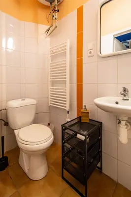 a bathroom with a toilet and a sink at Sweet Home by Ruterra in Prague