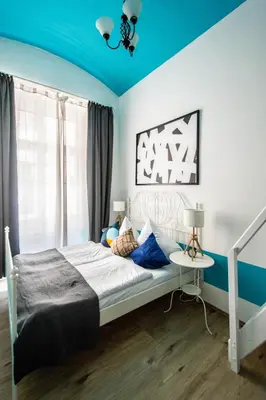 a bedroom with a bed with a blue ceiling at Sweet Home by Ruterra in Prague