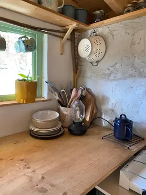 a kitchen counter with plates and utensils on it at Sušárna v zahradě s vůní bylinek in Křivoklát