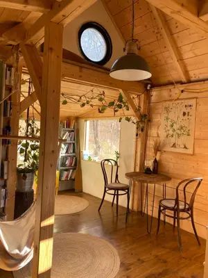 a room with a table and chairs in a cabin at Sušárna v zahradě s vůní bylinek in Křivoklát