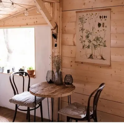 a wooden room with a wooden table and chairs at Sušárna v zahradě s vůní bylinek in Křivoklát