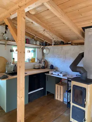 a kitchen with a stove top oven in a room at Sušárna v zahradě s vůní bylinek in Křivoklát
