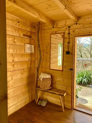 a wooden cabin with a bench and a window at Sušárna v zahradě s vůní bylinek in Křivoklát