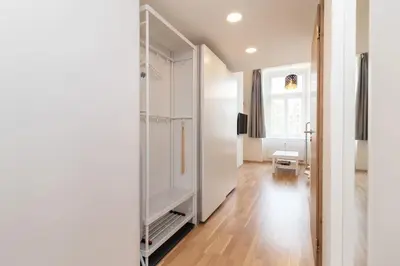 a room with a large white closet with a mirror at Mezzanine Beds, 10min to Centre with Offsite Parking in Prague