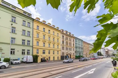 a city street with cars parked in front of buildings at Mezzanine Beds, 10min to Centre with Offsite Parking in Prague