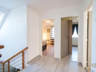 a room with a staircase and a bedroom with a bed at Holiday Home Starý Chodov by Interhome in Prague