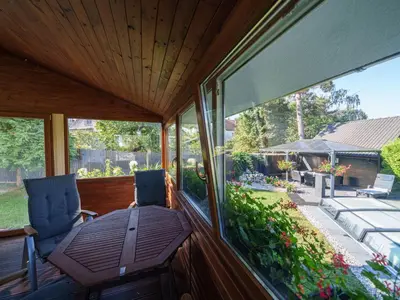 a screened in porch with chairs and a table at Holiday Home Starý Chodov by Interhome in Prague