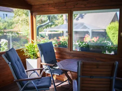 a screened in porch with a table and chairs at Holiday Home Starý Chodov by Interhome in Prague