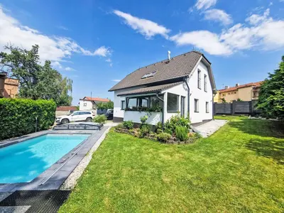 a swimming pool in a yard with an umbrella at Holiday Home Starý Chodov by Interhome in Prague