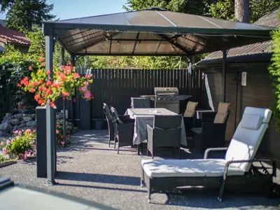 a patio with tables and chairs under an umbrella at Holiday Home Starý Chodov by Interhome in Prague