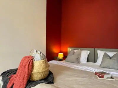 a bedroom with two beds and a purse on a bed at Red Currant - Prague Apartment in Prague