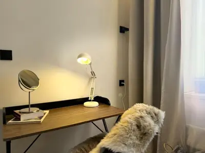 a living room with a couch and two tables at Red Currant - Prague Apartment in Prague