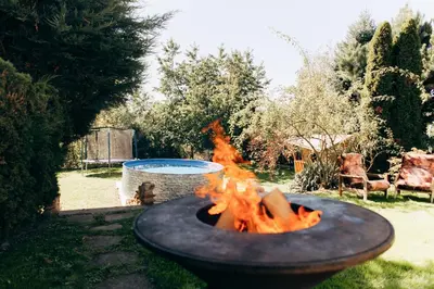a fire pit in a yard with a fire at DiamondVilla, 4 bedroom Apartment, garden & spa in Prague