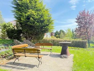 two benches and a bird bath in a park at DiamondVilla, 4 bedroom Apartment, garden & spa in Prague