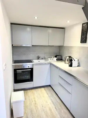 a kitchen with white cabinets and a counter top at Apartment by Charles Bridge in Prague