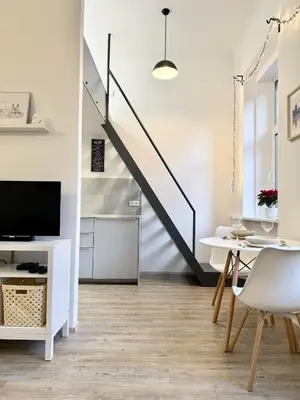 a living room with a table and a staircase at Apartment by Charles Bridge in Prague
