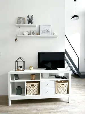a white entertainment center with a flat screen tv on top at Apartment by Charles Bridge in Prague