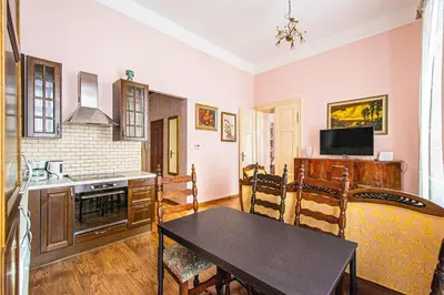 a kitchen with a table and a dining room at Astronomical Clock Suite by Ruterra in Prague