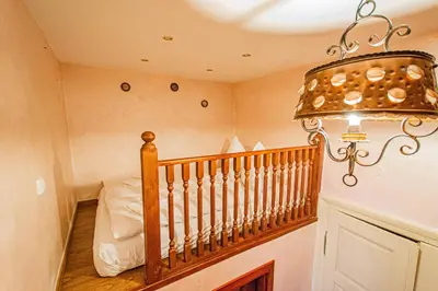 a room with a staircase with a chandelier at Astronomical Clock Suite by Ruterra in Prague