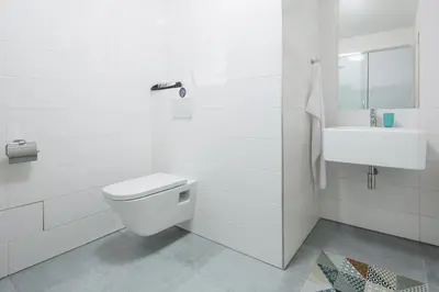 a white bathroom with a toilet and a sink at Best Place in Prague in Prague